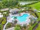 Community pool area with ample seating, lush landscaping, and a pergola for shade at 5540 Summit Gln, Bradenton, FL 34203