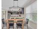 Bright dining area with modern chandelier and direct view to the kitchen with stainless appliances at 5540 Summit Gln, Bradenton, FL 34203