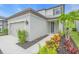 Charming home exterior featuring a manicured lawn, complemented by a vibrant garden and a neatly paved walkway at 5540 Summit Gln, Bradenton, FL 34203