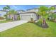 Charming home with landscaped front yard, healthy green lawn, and concrete driveway leading to a two-car garage at 5540 Summit Gln, Bradenton, FL 34203
