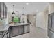 Open-concept kitchen flows into the living room with stainless appliances, granite island, bar seating, and lots of cabinet space at 5540 Summit Gln, Bradenton, FL 34203
