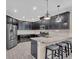 Modern kitchen with stainless steel appliances, granite countertops, an island with seating and dark cabinetry at 5540 Summit Gln, Bradenton, FL 34203