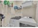 Well-organized laundry room includes a modern washer and dryer set with overhead wire rack shelving at 5540 Summit Gln, Bradenton, FL 34203