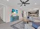 Bright living room seamlessly connects to the kitchen with a large couch, stylish rug, and view of the staircase at 5540 Summit Gln, Bradenton, FL 34203