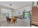 Bright living room with a ceiling fan, and open to the dining area and adjacent to the staircase at 5540 Summit Gln, Bradenton, FL 34203