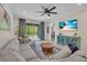 Comfortable living room featuring tile floors, ample seating, and backyard views at 5540 Summit Gln, Bradenton, FL 34203
