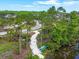 Walking path next to a pond and a kayak launch surrounded by beautiful trees and greenery at 5540 Summit Gln, Bradenton, FL 34203