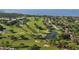 Scenic aerial view of a meticulously manicured golf course community with lush fairways, serene ponds, and beautiful homes at 5839 Los Verdes Ct, Bradenton, FL 34210