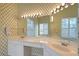 Bathroom featuring a large vanity with dual sinks, a big mirror with bright lighting, and a walk-in shower at 5839 Los Verdes Ct, Bradenton, FL 34210