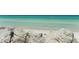 Beautiful beach view featuring tranquil turquoise water, kayakers, and white rocks at 5839 Los Verdes Ct, Bradenton, FL 34210