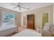 Bright bedroom with two twin beds and access to an enclosed outdoor patio area at 5839 Los Verdes Ct, Bradenton, FL 34210