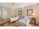 Charming bedroom with two twin beds and a window with plantation shutters at 5839 Los Verdes Ct, Bradenton, FL 34210