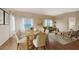 Elegant dining area featuring a wooden table with seating, open to a living room with plentiful natural light at 5839 Los Verdes Ct, Bradenton, FL 34210