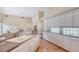 Open kitchen with granite countertops, white cabinets, stainless steel appliances, and light hardwood floors at 5839 Los Verdes Ct, Bradenton, FL 34210