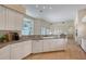 Bright kitchen featuring white cabinets, granite countertops, and a large window overlooking the outdoors at 5839 Los Verdes Ct, Bradenton, FL 34210