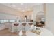 Kitchen with white cabinets, granite counters, breakfast bar and stainless appliances, next to eat-in area at 5839 Los Verdes Ct, Bradenton, FL 34210