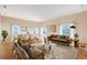 Spacious living room featuring hardwood floors, modern furniture, and large windows for ample natural light at 5839 Los Verdes Ct, Bradenton, FL 34210