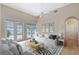 Bright living room with hardwood floors, white furniture, high ceilings and access to the outdoor area at 5839 Los Verdes Ct, Bradenton, FL 34210