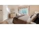 Bedroom with a bay window dressed with stylish curtains, a dresser, and a comfortable bed at 5839 Los Verdes Ct, Bradenton, FL 34210