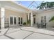 French doors offer a seamless transition from inside to outside in this screened-in patio at 5839 Los Verdes Ct, Bradenton, FL 34210