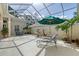 Relax and enjoy in this screened-in patio with lounge chairs, dining, and a fountain feature at 5839 Los Verdes Ct, Bradenton, FL 34210