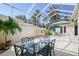 An outdoor dining set offers relaxation in this screened-in patio with a fountain feature at 5839 Los Verdes Ct, Bradenton, FL 34210