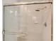 The shower features tile walls, glass doors, and a chrome shower head and fixtures at 5839 Los Verdes Ct, Bradenton, FL 34210