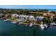 Waterfront condos with boat docks, a swimming pool, and lush landscaping offer luxurious coastal living at 615 Dream Island Pl # 105, Longboat Key, FL 34228