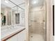 Neat bathroom featuring a glass enclosed shower and vanity with soft tone walls at 615 Dream Island Pl # 105, Longboat Key, FL 34228