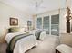 Comfortable bedroom with twin beds, soft carpeting, and large windows allowing for ample natural light at 615 Dream Island Pl # 105, Longboat Key, FL 34228