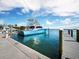 Yacht docked near condos with fishing gear at sunset at 615 Dream Island Pl # 105, Longboat Key, FL 34228
