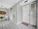 Exterior entrance to unit with white door, tile floor, and seating area at 615 Dream Island Pl # 105, Longboat Key, FL 34228