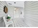 Exterior entrance with white tile floors, seating area, and neutral paint at 615 Dream Island Pl # 105, Longboat Key, FL 34228