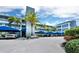 Harbour Villa Club's exterior featuring covered parking, lush tropical landscaping, and multi-story building at 615 Dream Island Pl # 105, Longboat Key, FL 34228