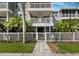 Exterior of condo with view of balconies, manicured lawn, and walkway at 615 Dream Island Pl # 105, Longboat Key, FL 34228