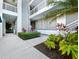 Condo exterior with lush landscaping, steps to the units, and shaded walkways at 615 Dream Island Pl # 105, Longboat Key, FL 34228