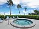 Relaxing hot tub area with lounge chairs and manicured greenery, perfect for enjoying sunny days and calm evenings at 615 Dream Island Pl # 105, Longboat Key, FL 34228