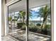 Waterfront lanai with tile floors and access to community pool and beach at 615 Dream Island Pl # 105, Longboat Key, FL 34228