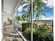 Screened lanai with tile floors and waterfront views of a tropical community at 615 Dream Island Pl # 105, Longboat Key, FL 34228
