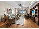 Cozy living room with hardwood floors, comfortable seating, and sliding glass doors to a lovely outdoor patio at 615 Dream Island Pl # 105, Longboat Key, FL 34228