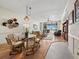 Bright living room with water views, wicker furniture, and hardwood flooring, perfect for relaxing and entertaining guests at 615 Dream Island Pl # 105, Longboat Key, FL 34228