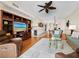 Stylish living room boasts a built-in entertainment center, wood floors, and a peek into the dining area at 615 Dream Island Pl # 105, Longboat Key, FL 34228