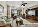 Inviting living room featuring comfortable seating, a ceiling fan, and sliding doors to an outdoor patio space at 615 Dream Island Pl # 105, Longboat Key, FL 34228