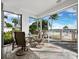 Inviting tiled patio with comfortable seating and picturesque views of the beautiful waterway and palm trees at 615 Dream Island Pl # 105, Longboat Key, FL 34228