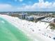 Overhead shot of beachfront condos and sunny beach fronting clear turquoise water at 6312 Midnight Pass Rd # 102S, Sarasota, FL 34242