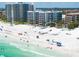 Aerial view of beach and condos on a bright sunny day with white sandy shores at 6312 Midnight Pass Rd # 102S, Sarasota, FL 34242
