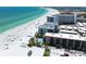 Breathtaking aerial view of a beachfront condo community with white sand beach and turquoise water at 6312 Midnight Pass Rd # 102S, Sarasota, FL 34242