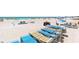 Stacks of beach chairs on the beach near the Gulf of Mexico on a sunny day at 6312 Midnight Pass Rd # 102S, Sarasota, FL 34242