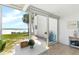 Interior with scenic beach view visible through large sliding glass doors at 6312 Midnight Pass Rd # 102S, Sarasota, FL 34242