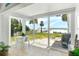 Inviting interior space with a picturesque beach view through large sliding glass doors at 6312 Midnight Pass Rd # 102S, Sarasota, FL 34242